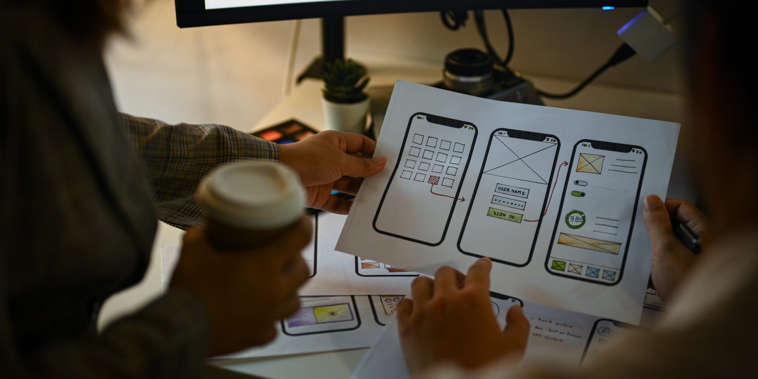 Creative designer team working with template layout framework for mobile phone application